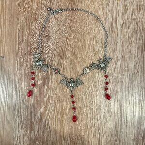 Handmade bats goth necklace 
Silver with red accents 
Bought off Etsy